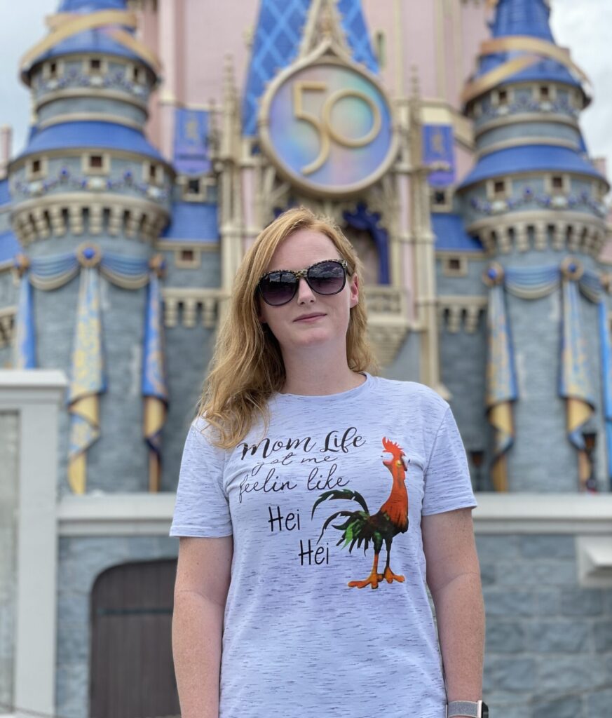 lady standing in front of the castle at magic kingdom